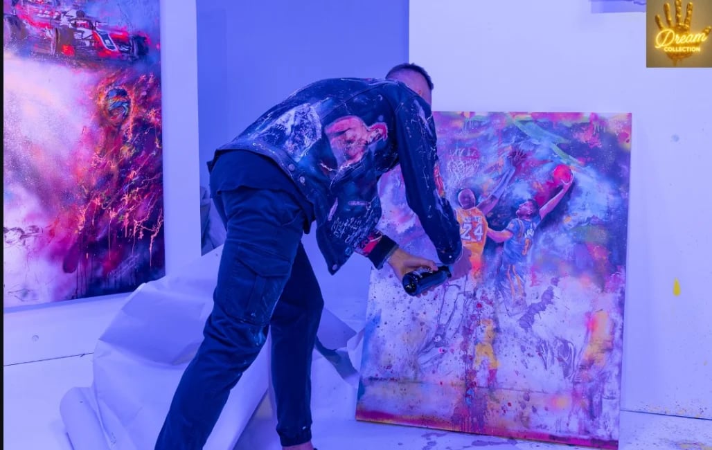 Person interacting with colorful abstract artwork in gallery